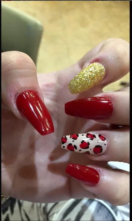 Red and gold nails with a glitter accent