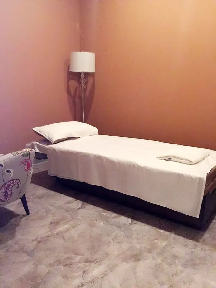 A calm treatment room with massage beds