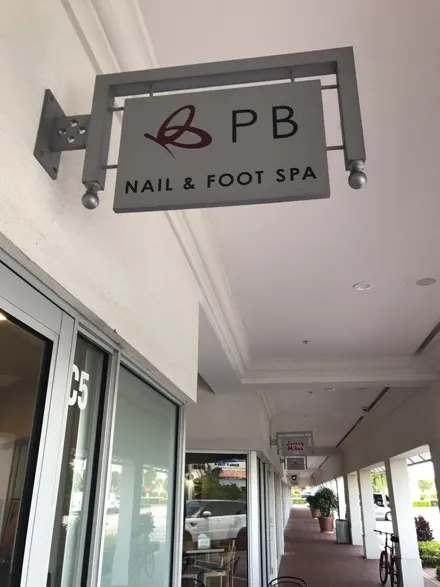 The Palm Beach Nails and Foot Spa sign hanging at our salon