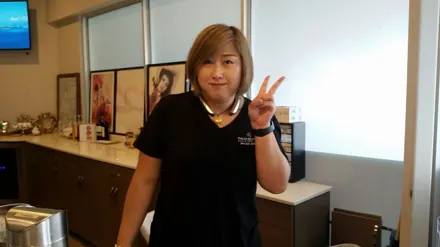 A member of our team at the front desk, waving hello